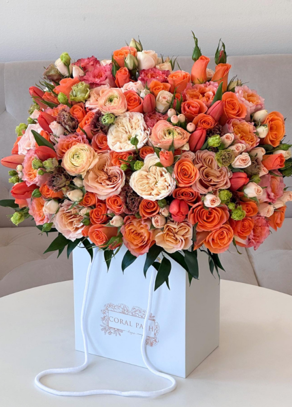 Fall inspired flowers featuring bright orange roses, ivory garden roses and other fillers.