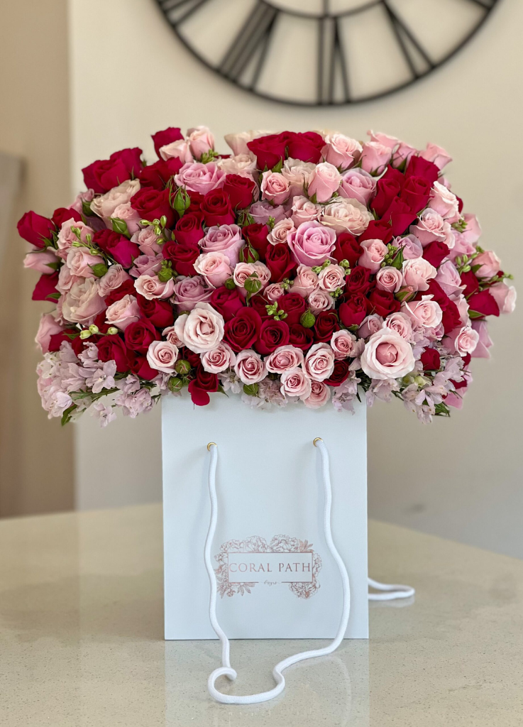 Barbie themed flowers with roses and spray roses in an arrangement