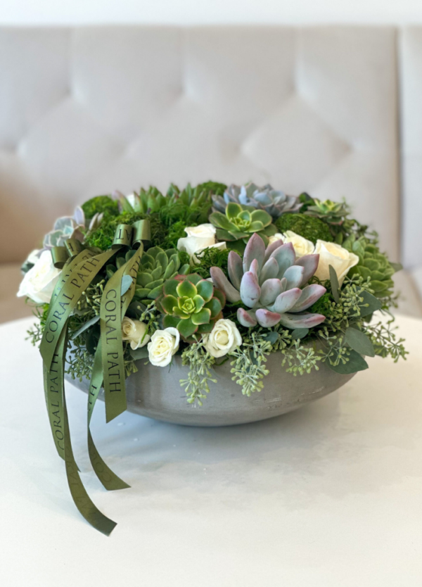 Low profile concrete bowl with preserved moss, succulents, eucalyptus, and spray roses