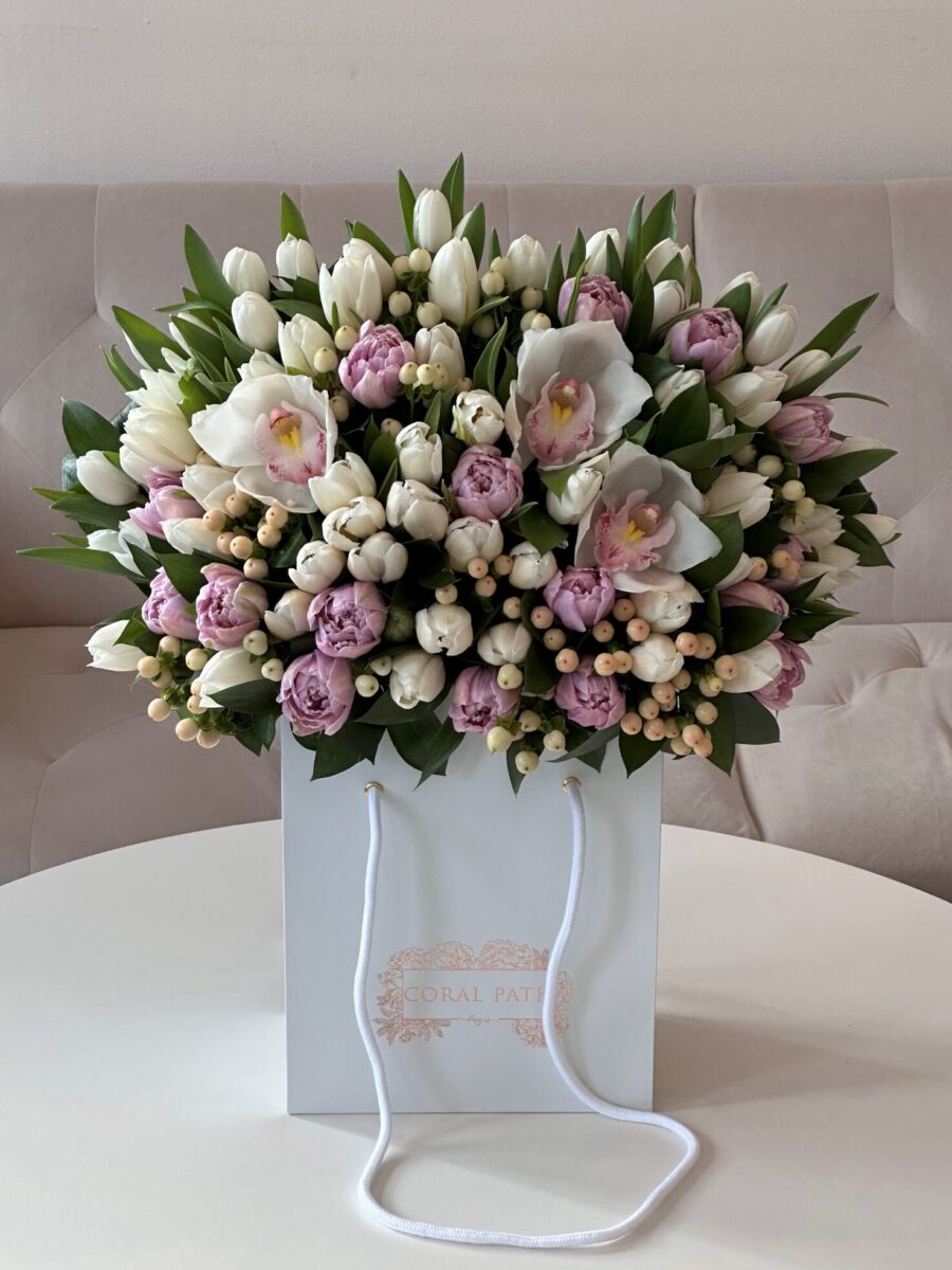 White and Purple Tulips, White Hypericums, and Cymbidium orchids arranged in a flower bouquet.