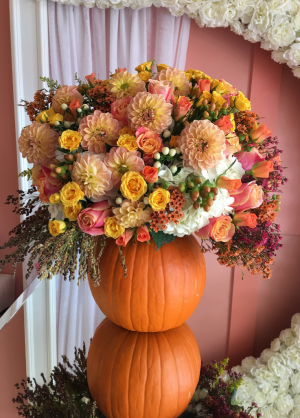 Flowers arranged on a real pumpkin with dahlias and more.