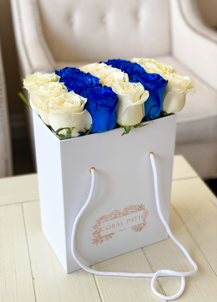 Blue and white roses neatly arranged in a flower bag.