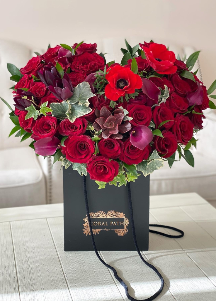 A mix of delicate and vibrant red florals mashed up in the shape of a heart.