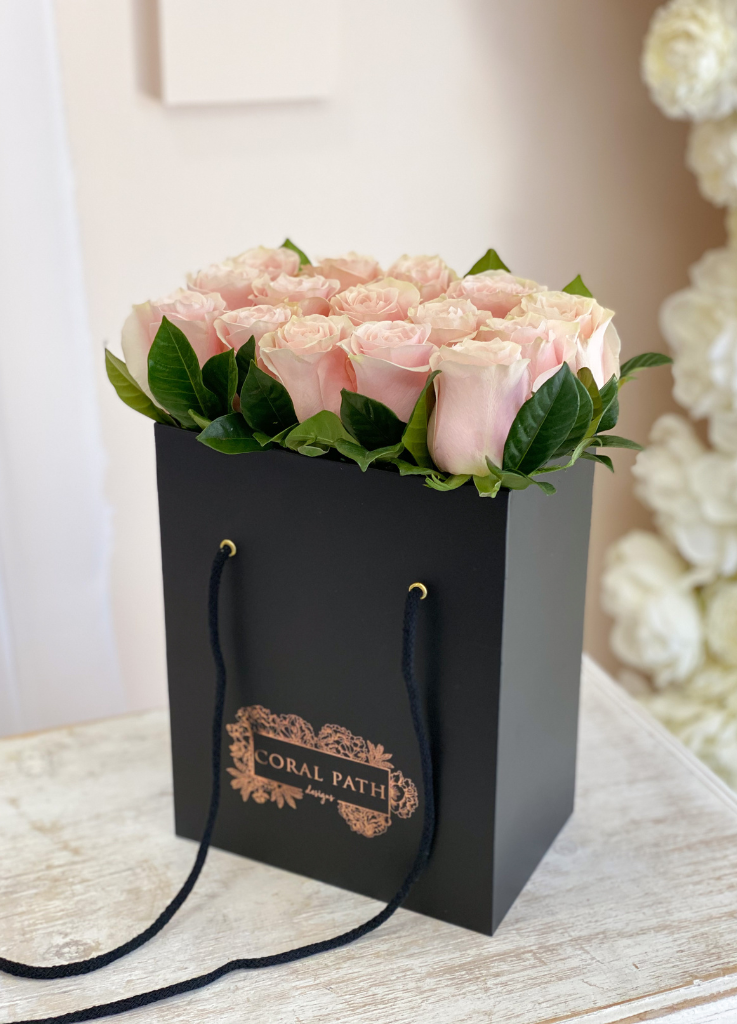Pastel Pink roses neatly arranged in a flower bag.