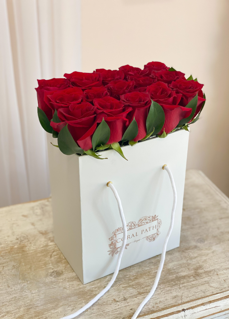 Red roses neatly arranged in a bag box from Coral Path