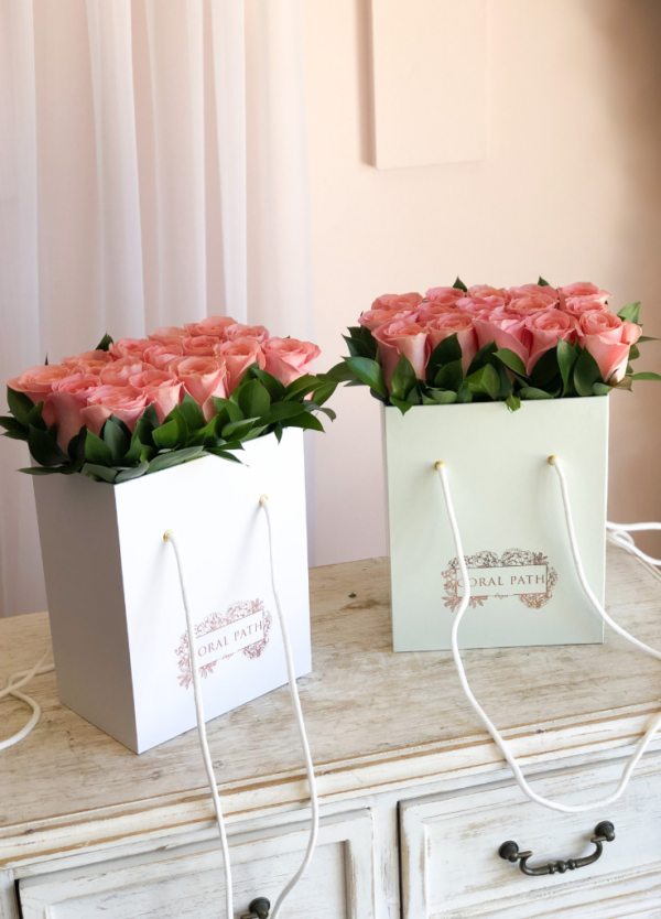 Hermosa roses neatly arranged in signature bag boxes.