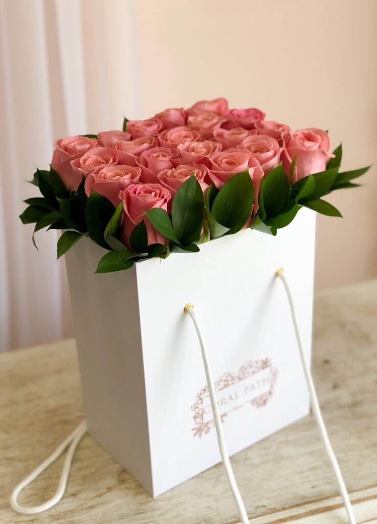 Hermosa roses neatly arranged in signature bag boxes.