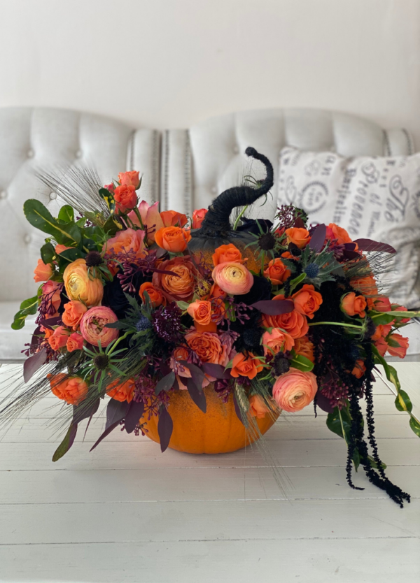 Halloween flowers arranged on a pumpkin