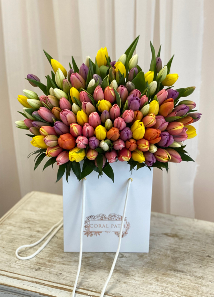 A bunch of tulips arranged neatly in a flower bag.