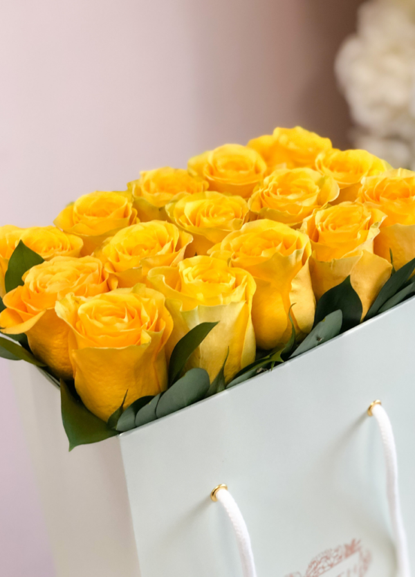 Yellow roses neatly arranged in a flower bag.