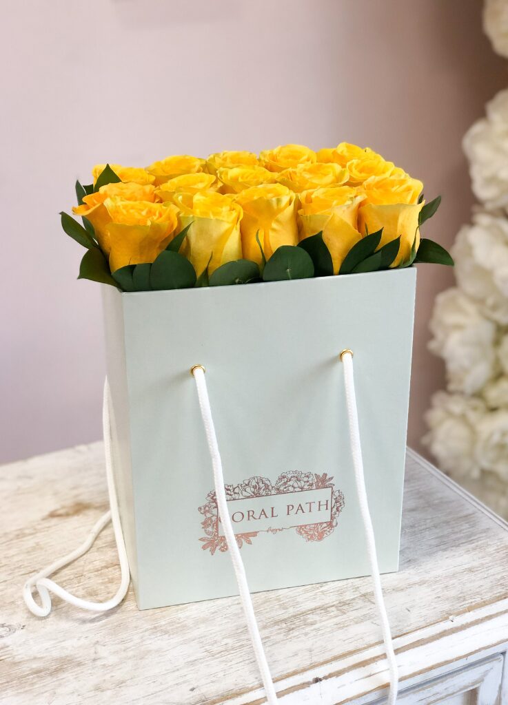 Yellow roses neatly arranged in a flower bag.