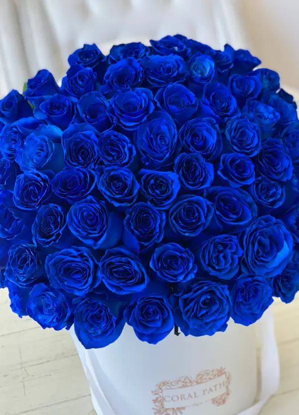 Close up of blue roses in a hat box.