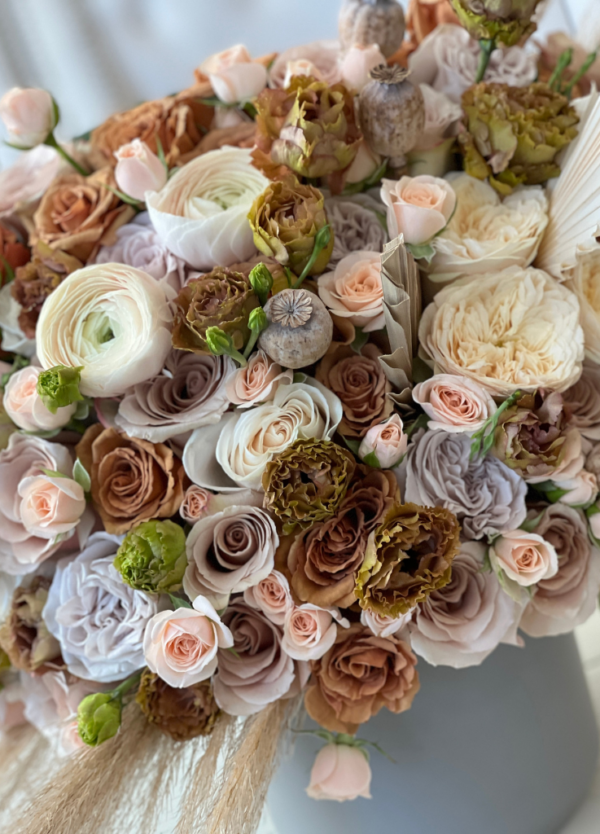Image of 'Jolene' flower arrangement, featuring vintage-inspired Toffee roses, neutral palette, dried pampas grass, and fan leaves for an elegant display.