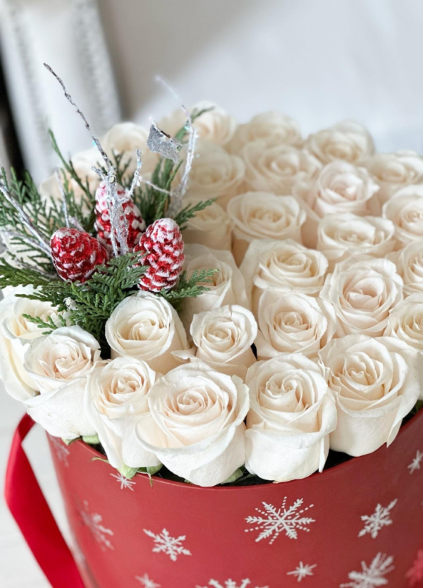 Experience holiday joy with "Oh What Fun Roseyln," featuring ivory roses and festive props, a perfect addition to your seasonal decor.