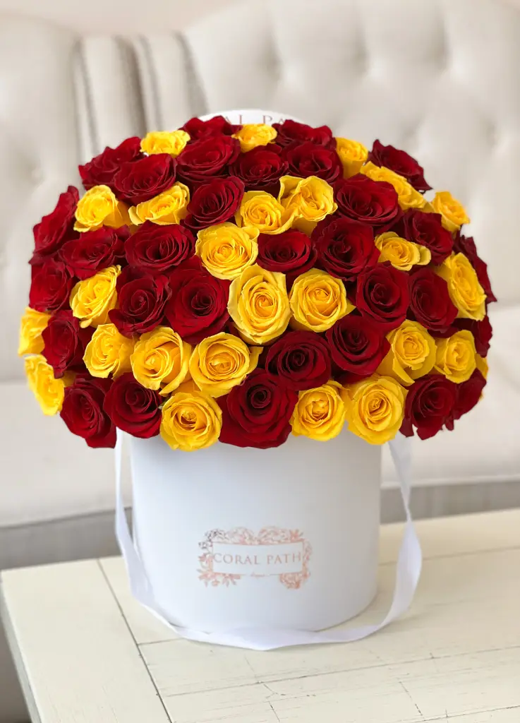 Red and yellow roses in a hat box