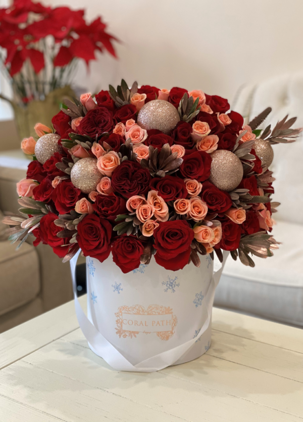 "Rose Gold Christmas" arrangement featuring red and pink roses with rose gold branch fillers, adding festive glamour to your holiday decor.