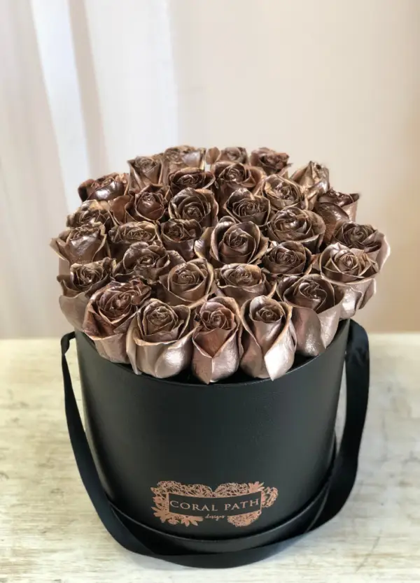 Rose gold roses in a hat box