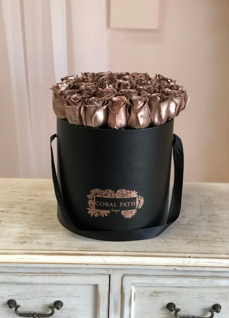 Rose gold roses in a hat box