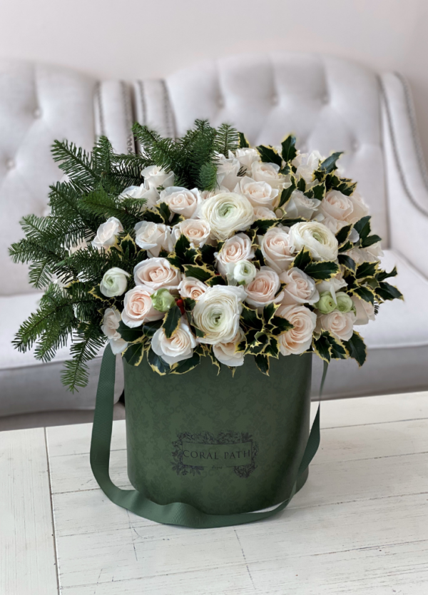 Image description: Winter floral arrangement with white roses and ranunculus, evoking a serene winter landscape in the Holiday Collection.