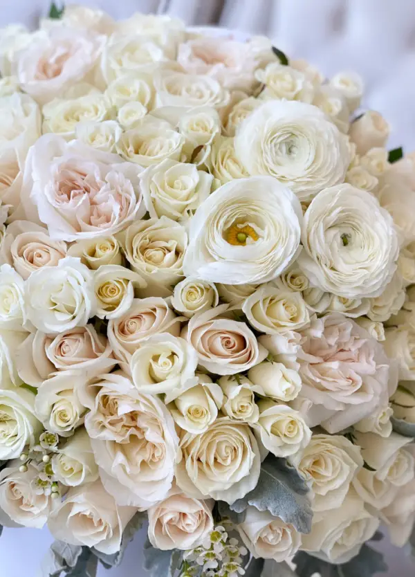 White, blush and ivory flowers and roses mixed up in a hat box.