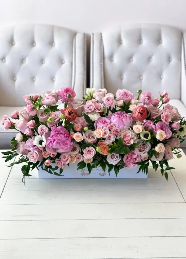 Dreamy pastel pink flowers in a long centerpiece box.