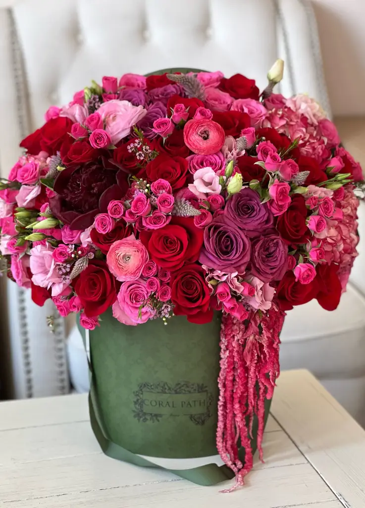 Bold and vibrant colors of burgundy and hot pink roses, ranunculus and amaranthus.