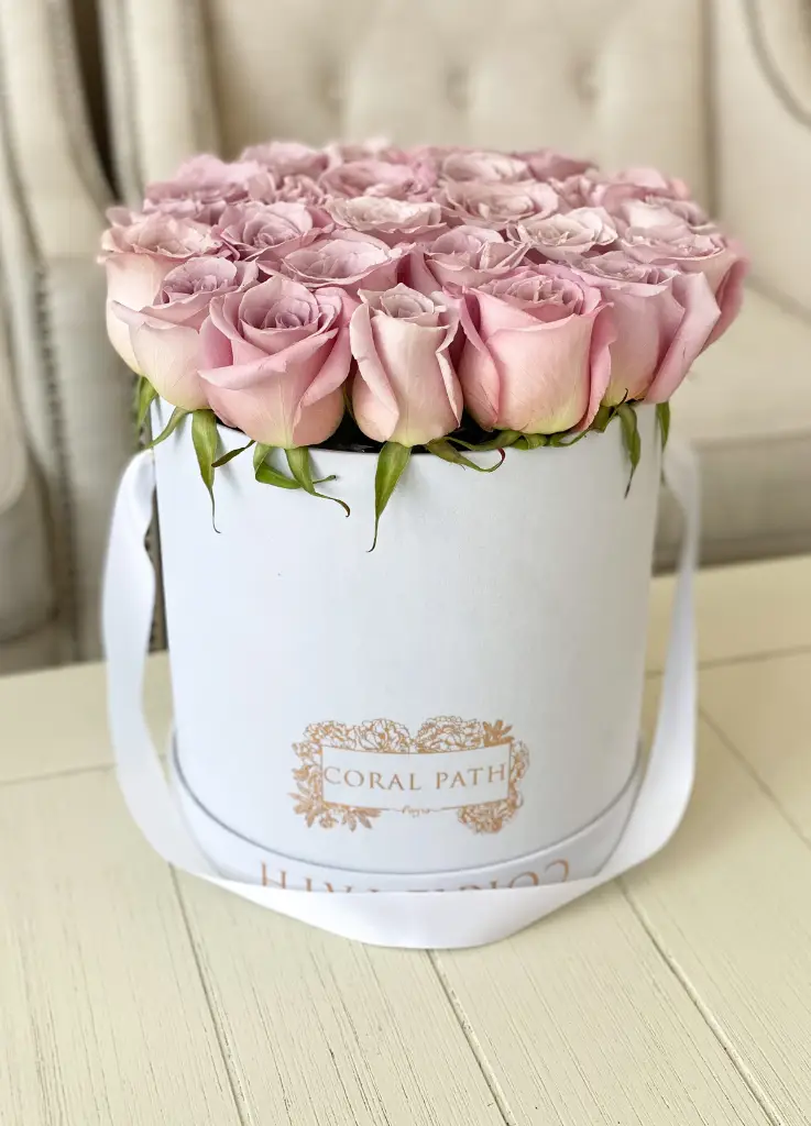 Faith lavender roses arranged in a hat box.