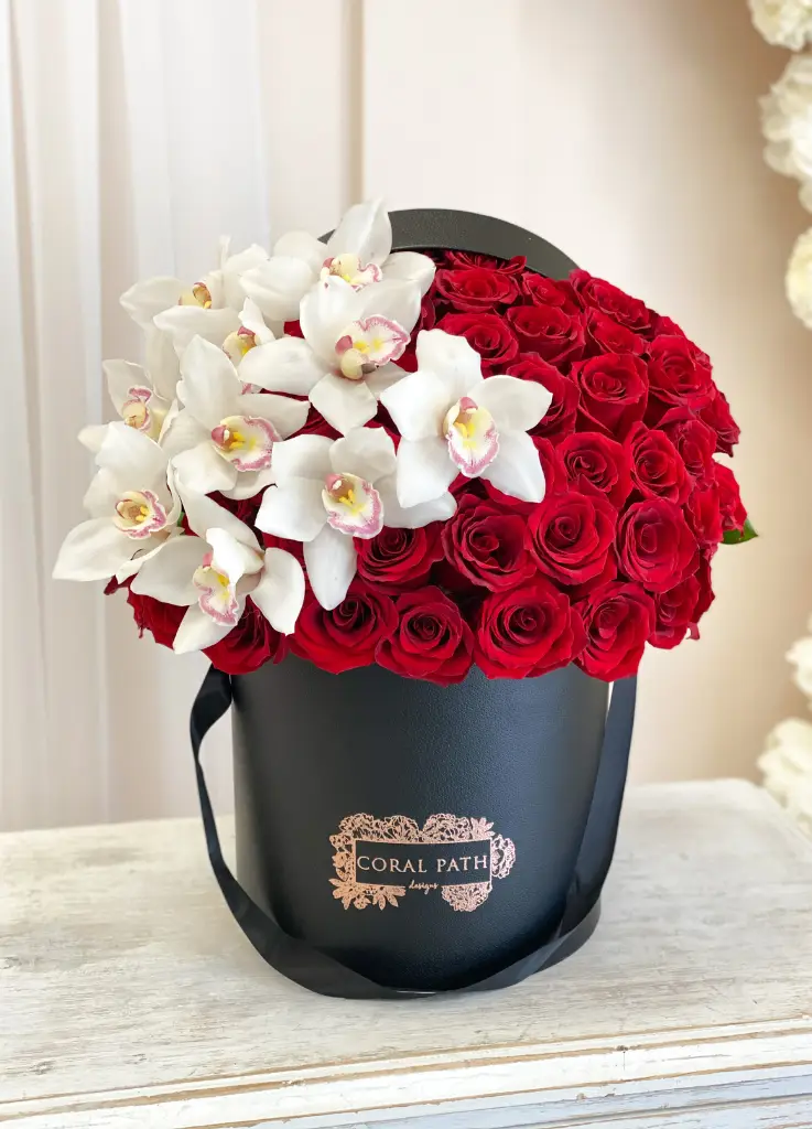 French hat box with red roses and orchids.