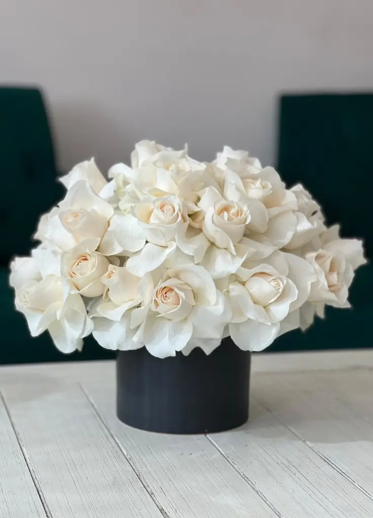 Vendela or ivory reflexed roses arranged in a vase.