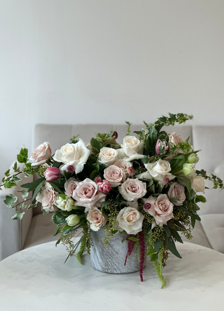 quicksand roses, double tulips, and amaranthus in a concrete bowl