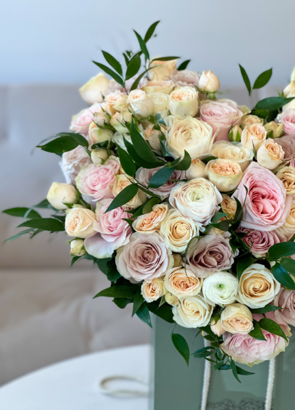flower arrangement shaped like a heart with garden roses, roses, ranunculus and more.