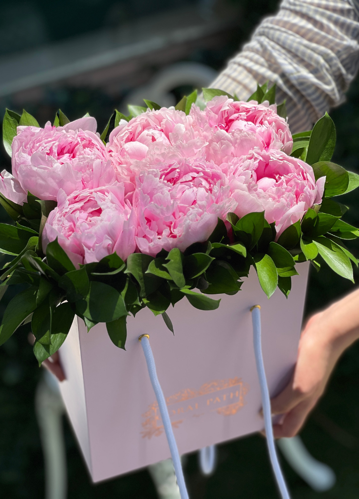 peonies and ruscus in a bag
