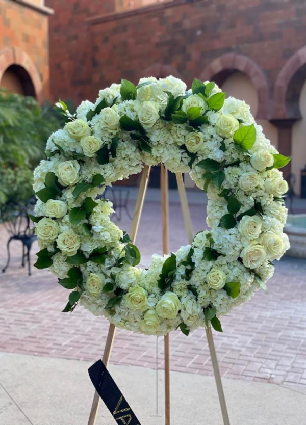 standing circle wreath with hydrangeas roses and greenery.
