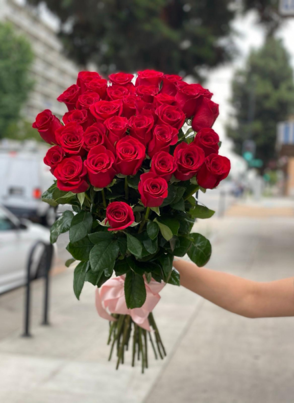 red roses tied up in a bouquet