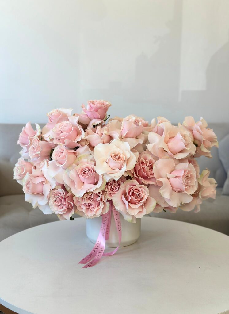 Light pink reflexed roses in a vase. Pink mondial roses.