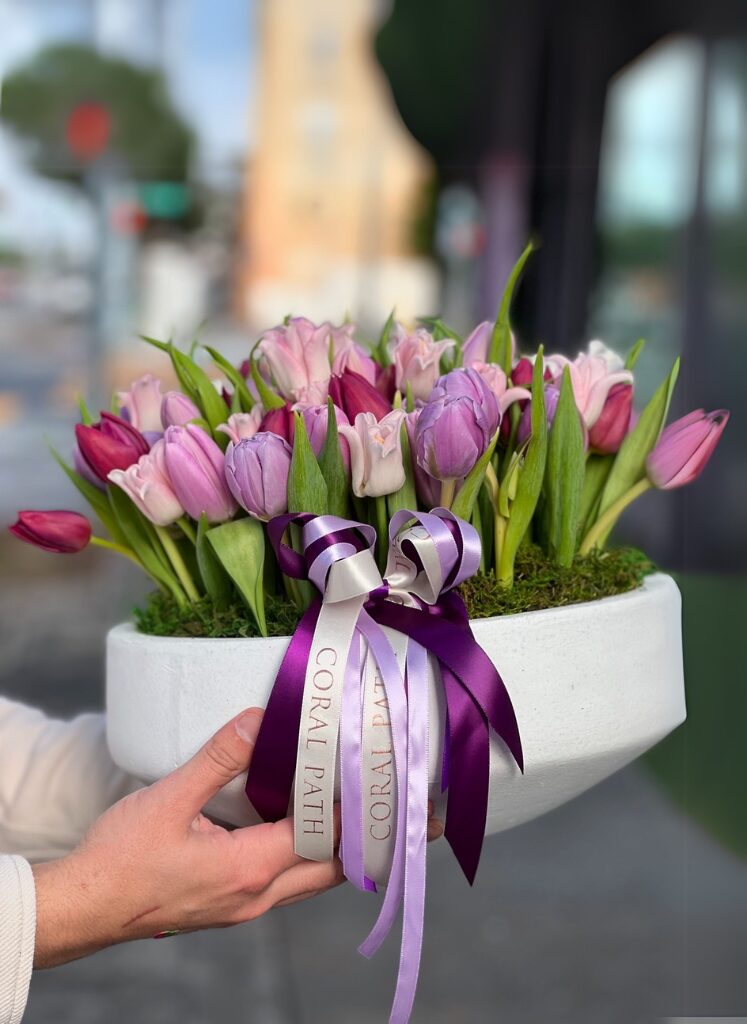 beautiful tulips in an short bowl with ribbons