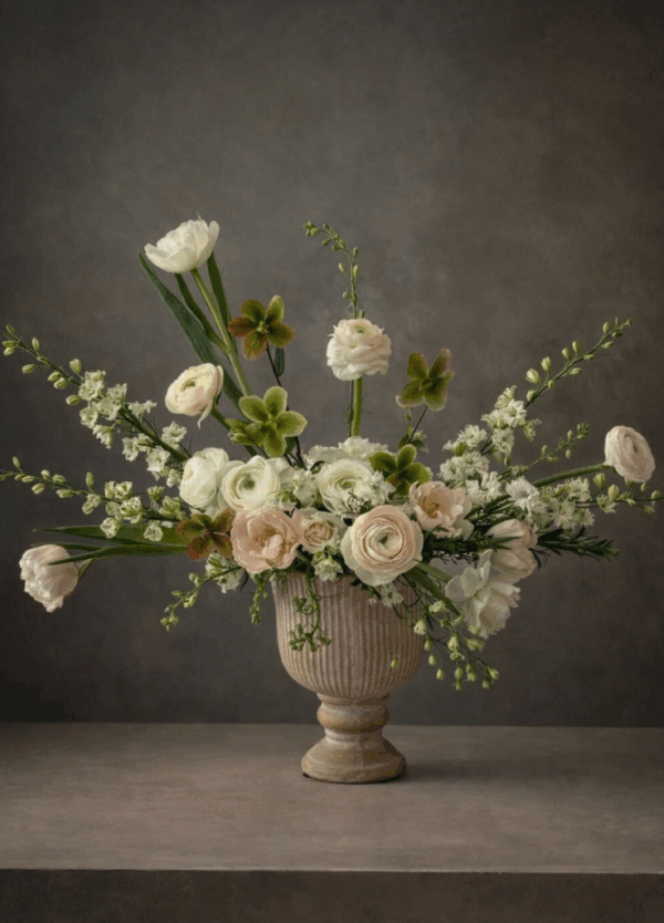 fleurina style florals, in a pedestal vase with garden roses and ranunculus